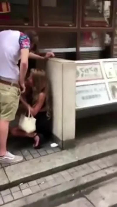 Foreign boyfriend feeds his girlfriend breakfast on the roadside