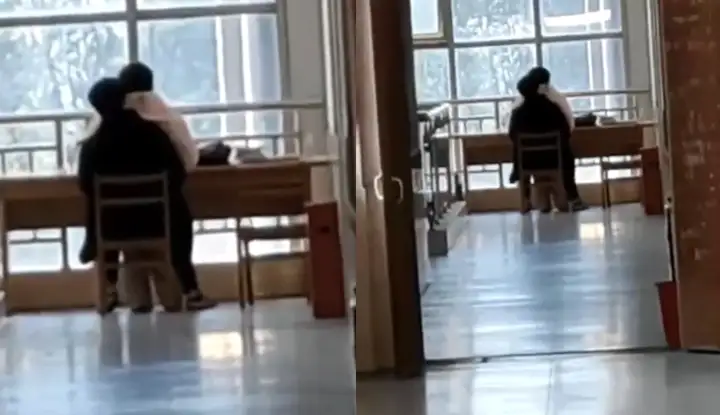 In the library of the Vocational and Technical College of Industry and Commerce in Anhui, China, a young couple is having sex on the seat with the girl on top.